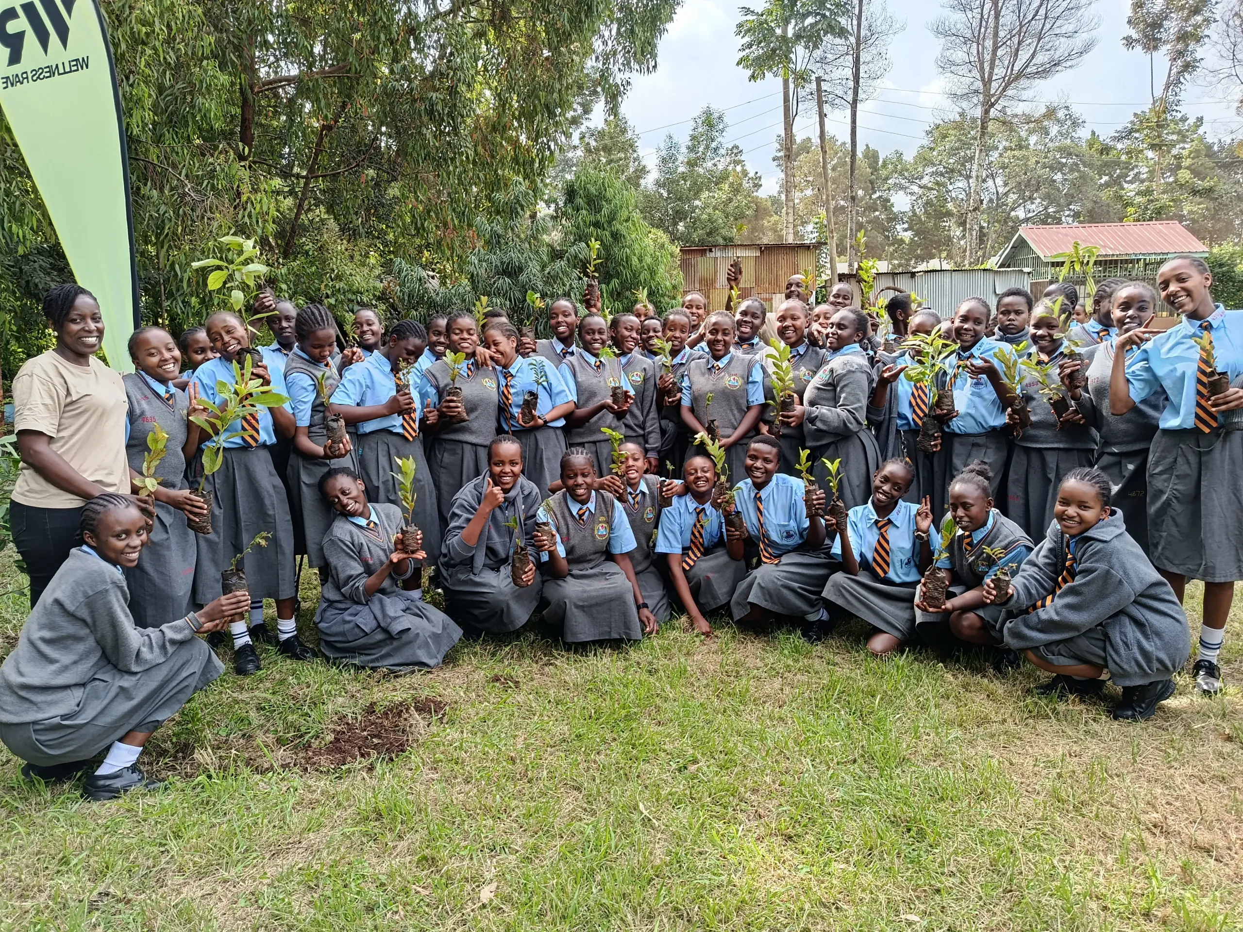 Children planting fruit trees at a school in Kenya