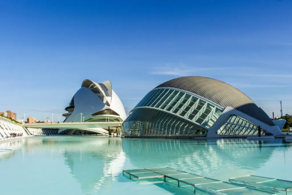 Valencia City of Arts and Sciences reflected in water under a clear blue sky