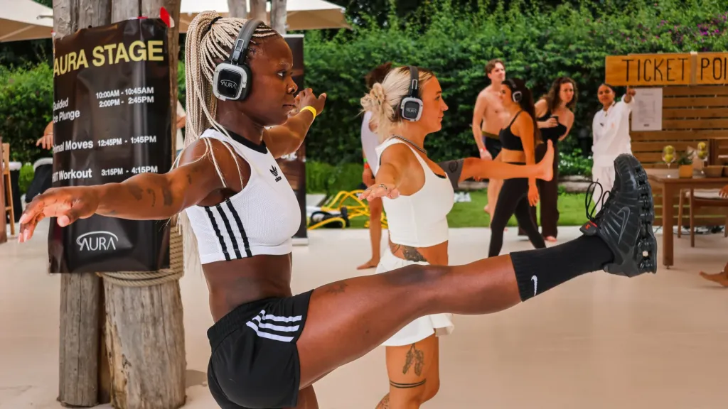 People moving together in silent-disco headphones at a Wellness Rave morning session in Barcelona